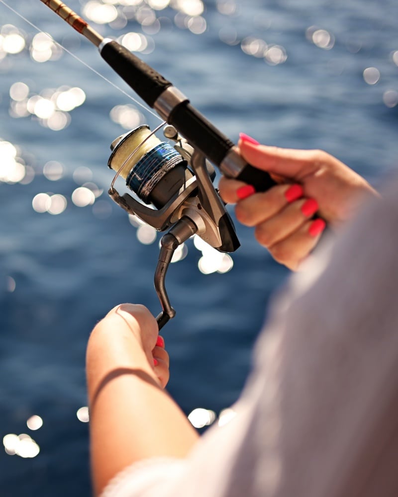 A,Fishing,Rod,With,Fishing,Line,In,The,Hands,Of